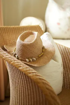 a straw hat sitting on top of a chair at Driftwood B&B in Porthscatho