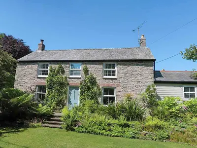 an old stone house with ivy growing on it at Greenbank in Veryan