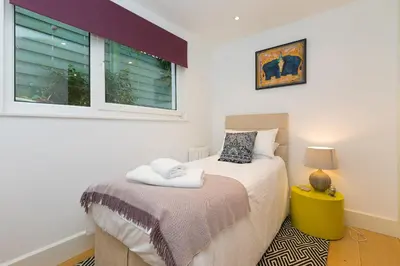 a bedroom with a bed and a window at The Breakers in Carbis Bay