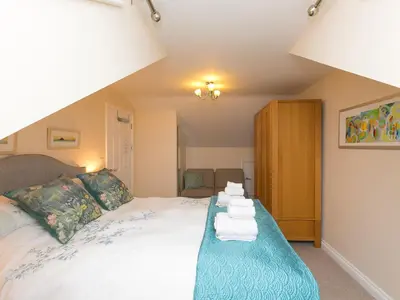 a bedroom with a bed with towels on it at Laurellie in Carbis Bay