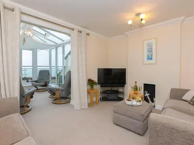 a living room with a couch and a television at Laurellie in Carbis Bay