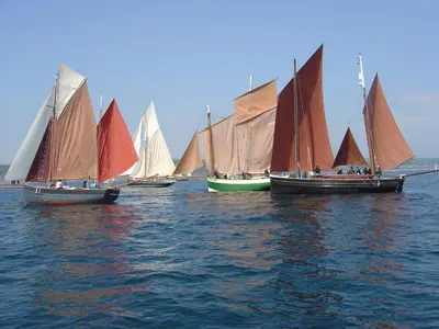 a group of small sailboats in the water at The Old Bridge House in Looe