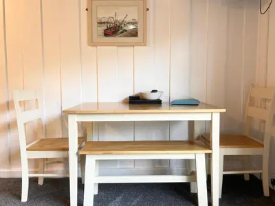 a white table and two chairs and a table and a table at Gorgeous Cottage at Crackington Haven, near Bude and Boscastle, Cornwall in Bude
