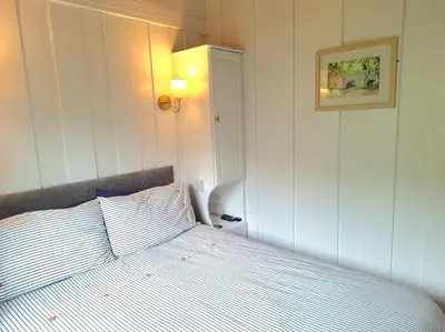 a bedroom with a bed and a picture on the wall at Gorgeous Cottage at Crackington Haven, near Bude and Boscastle, Cornwall in Bude
