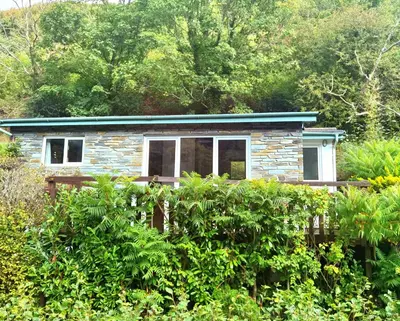 a small stone house with a green roof at Gorgeous Cottage at Crackington Haven, near Bude and Boscastle, Cornwall in Bude