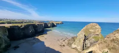 a view of a beach with rocks and the ocean at 3-Bedroom Holiday Home with Valley Views in Newquay