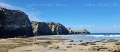 a view of a beach with rocks and the ocean at 3-Bedroom Holiday Home with Valley Views in Newquay