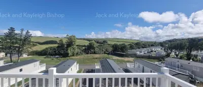 arial view of a town with buildings and trees at 3-Bedroom Holiday Home with Valley Views in Newquay