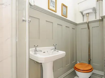 a bathroom with a white sink and a toilet at Sunset House in Newquay