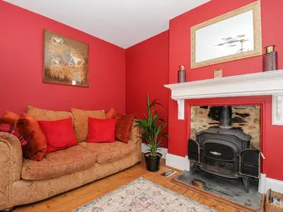 a living room with a couch and a fireplace at Sunset House in Newquay