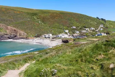 a village on a hill next to a beach at Bantry Cottage at Crackington Haven, near Bude and Boscastle, Cornwall in Bude