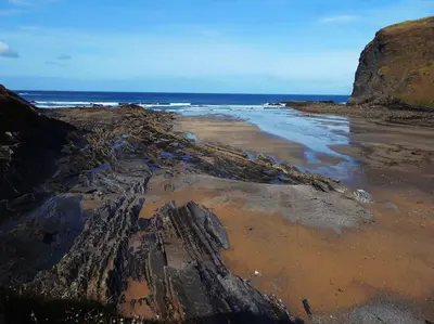 an aerial view of a rocky beach with the ocean at Kallowen Cottage at Crackington Haven, near Bude and Boscastle, Cornwall in Bude