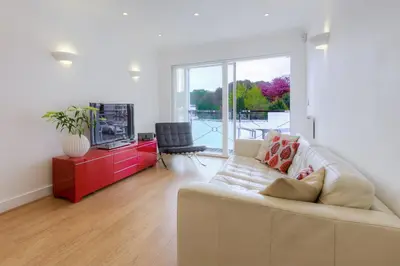 a living room with a couch and a tv at Indigo in St Ives