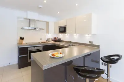 a kitchen with a counter with a plate of food on it at Indigo in St Ives