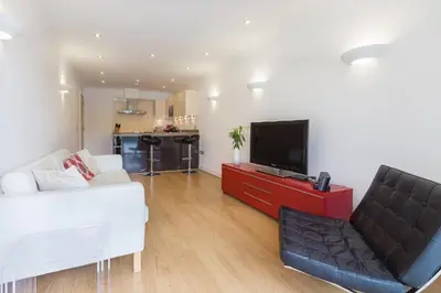 a living room with a white couch and a television at Indigo in St Ives