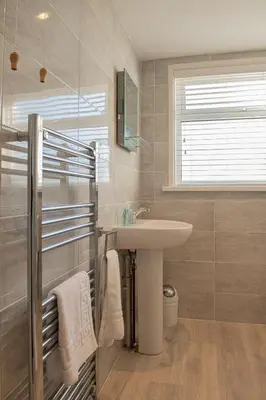 a bathroom with a sink and a mirror at Trevarrian Lodge in Newquay