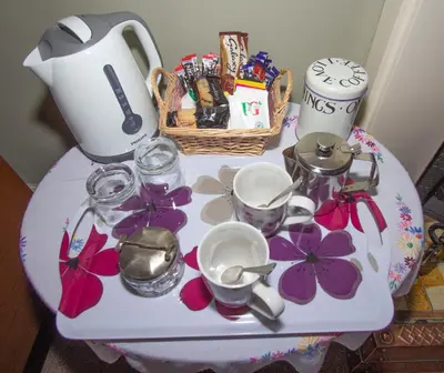 a table with a tea pot and dishes on it at Penrose Bed & Breakfast in Lostwithiel