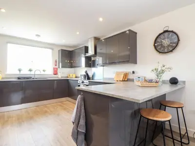 a kitchen with a large counter with two stools at Atlantic Reach in Marazion