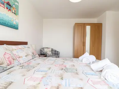 a bedroom with a large bed with towels on it at Atlantic Reach in Marazion