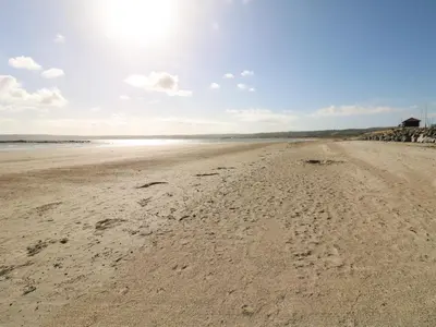 a sandy beach with footprints in the sand at Atlantic Reach in Marazion