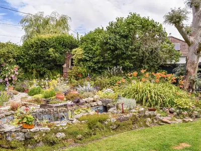 a garden with many different flowers and plants at Tinners Gate in Saint Cleer