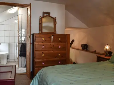 a bedroom with a dresser and a mirror at Tinners Gate in Saint Cleer