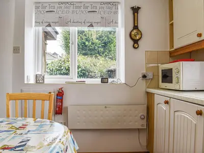 a kitchen with a microwave and a window at Tinners Gate in Saint Cleer