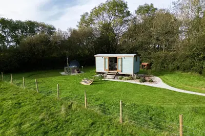 a tiny house in the middle of a field at Fern in Bude