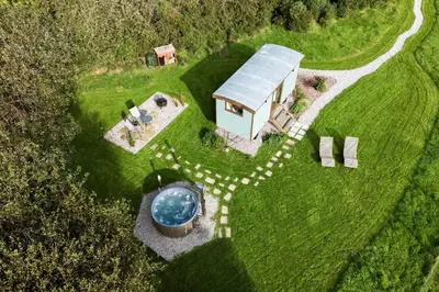 an aerial view of a house with a swimming pool at Fern in Bude