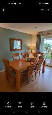 a dining room with a wooden table and chairs at Stunning Holiday home with amazing surroundings! in Budock Water