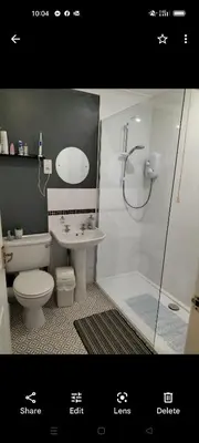 a bathroom with a toilet and a sink and a shower at Stunning Holiday home with amazing surroundings! in Budock Water