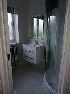 a bathroom with a sink and a shower and a toilet at Elysian Fields B&B in Helston
