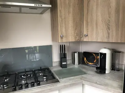a kitchen with a stove and a stove top oven at Mawgan Stays Mawgan Porth in Mawgan Porth