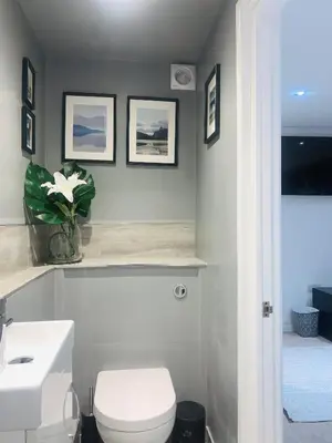 a bathroom with a white toilet and a sink at TRIG-Private Studio, Courtyard, Walk to Fistral in Newquay