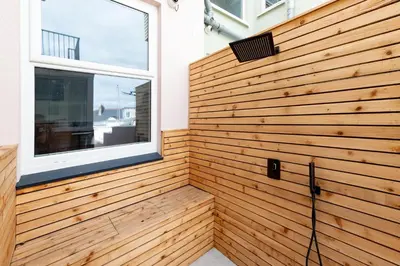 a wooden wall in a room with a window at TRIG-Private Studio, Courtyard, Walk to Fistral in Newquay