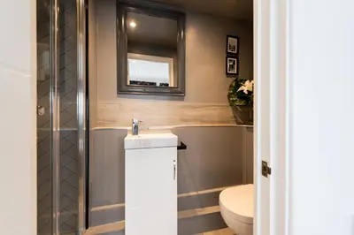 a bathroom with a sink and a toilet and a tub at TRIG-Private Studio, Courtyard, Walk to Fistral in Newquay