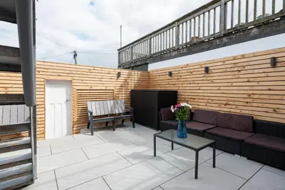 a patio with a couch and a table at TRIG-Private Studio, Courtyard, Walk to Fistral in Newquay
