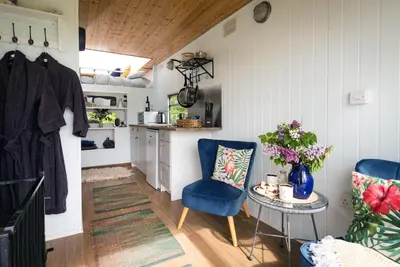 a room with a table and two chairs and a kitchen at Safari Cornwall in Bodmin