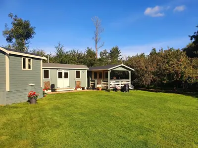 a large yard with a small house and a house at Safari Cornwall in Bodmin