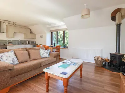 a living room with a couch and a table at The Mews in Bodmin
