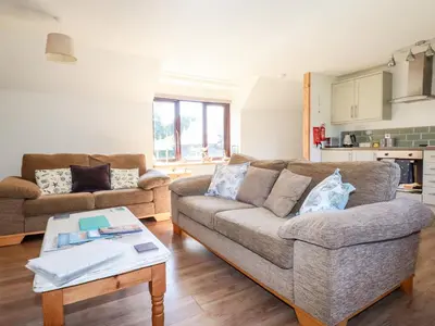 a living room with a couch and a table at The Mews in Bodmin