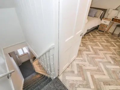 a room with a stairway with a bed and a stair case at Chy An Mor in Mevagissey