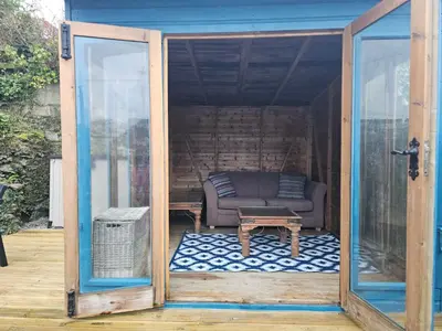 a living room with a couch and a table at Chy An Mor in Mevagissey