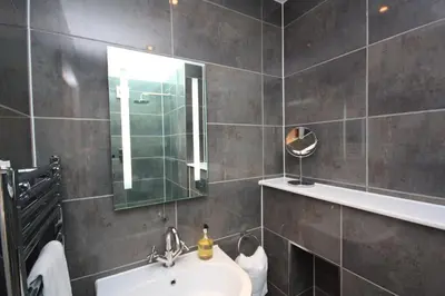 a bathroom with a sink and a mirror at House 1 in Looe