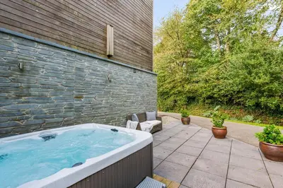 a jacuzzi tub sitting on a patio at House 1 in Looe