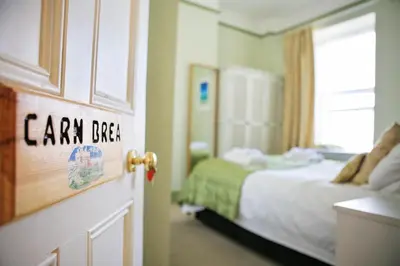 a room with a bedroom with a bed and a window at Blue Sky Bed and Breakfast in St Ives