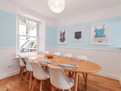 a dining room with a wooden table and chairs at Rock Lobster in Helston