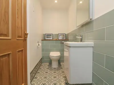 a bathroom with a toilet and a sink at Rock Lobster in Helston