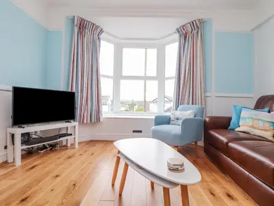 a living room with a couch and a tv at Rock Lobster in Helston