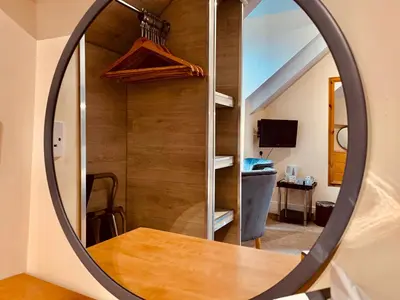 a mirror in a room with a wooden wall at Membly Hall Hotel in Falmouth